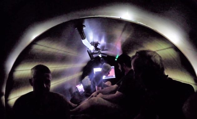Silhouetted Titan crew