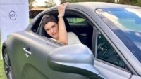 Kim Sherwood in sports car