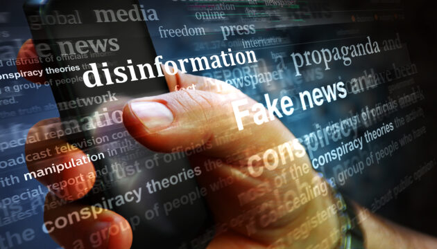 Illustration: A stream of words about disinformation superimposed on image of a hand holding a mobile device