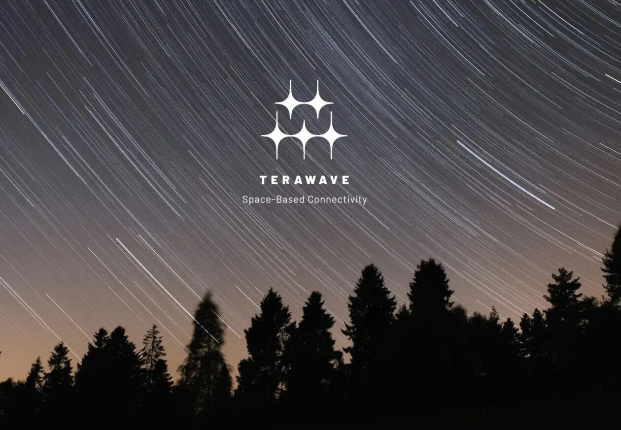 TeraWave logo superimposed on image of trees and sky with star trails